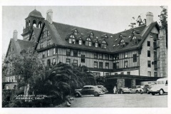 A vintage black-and-white photo of the Claremont Hotel in Berkeley, California. The building features a Tudor-style design with steep roofs and dormer windows. Vintage cars are parked in front. Text reads Claremont Hotel Berkeley, Calif B-51.