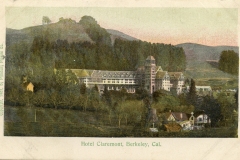 A vintage postcard depicting Hotel Claremont, Berkeley, California, surrounded by hills and trees. The hotel is a large, multi-story building with a central tower. The landscape includes smaller buildings and a windmill.