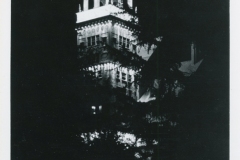 Black and white image of the Hotel Claremont, featuring its illuminated tower at night. The tower is surrounded by trees, and text below reads: Hotel Claremont, High Atop the Berkeley Hills, Berkeley, California.