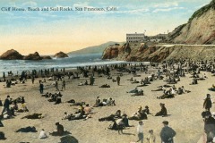 A vintage postcard shows a crowded beach near cliffs in San Francisco, with many people lounging on the sand. In the background are large rocks in the ocean and the iconic Cliff House, San Francisco, California.
