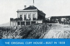 Black-and-white photo of the original Cliff House in San Francisco, built in 1858, perched on a cliff edge. People stand on the porch, and horse-drawn carriages are visible to the right. Text reads: THE ORIGINAL CLIFF HOUSE—BUILT IN 1858.