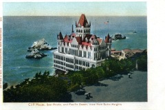 Historic postcard illustration of the Cliff House in San Francisco, showcasing its ornate Victorian architecture, red roofs, and turrets overlooking Seal Rocks and the Pacific Ocean; view from Sutro Heights.