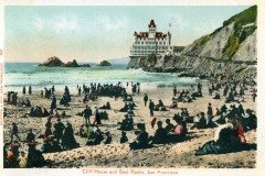 Vintage postcard depicting a crowded San Francisco beach, with people in early 20th-century clothing, the iconic Cliff House perched on a cliff, and waves crashing near Seal Rocks.