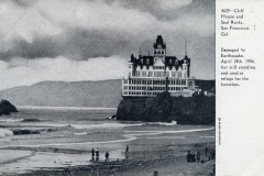 Historic black-and-white photo of San Francisco’s Cliff House perched on a rocky cliff above the ocean, with several people walking on the beach below; a caption describes earthquake damage in 1906.