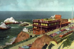 A vintage postcard shows the Cliff House in San Francisco overlooking the ocean, with classic cars parked nearby, rocky shorelines, and small islands in the background. People stroll along pathways near the iconic seaside building.