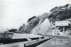 Black-and-white photo of a coastal road curving past a rocky hill with trees, a large Cliff House and Sutro Heights Gift Shop sign, and a historic building; text reads Cliff House and Sutro Heights, San Francisco.