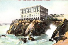 A historic postcard illustration shows San Franciscos iconic Cliff House, a large rectangular building perched atop rocky cliffs overlooking the ocean, with waves crashing below and people gathered outside.
