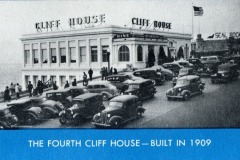 Black-and-white photo of the Fourth Cliff House in San Francisco, built in 1909, with vintage cars parked out front and a sign reading Cliff House on the building.