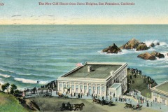 Illustrated postcard of the Cliff House by the ocean in San Francisco, California, with crowds of people outside, horse-drawn carriages, and rocky cliffs visible in the background.