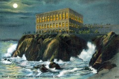 A large, brightly lit building—San Francisco’s iconic Cliff House—sits atop rocky cliffs overlooking the ocean at night, with waves crashing below and a full moon shining in the cloudy sky. The text reads: “Night scene at Cliff House, San Francisco, Cal.”.