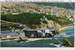 A vintage postcard illustration of Seal Rocks and the iconic Cliff House along San Francisco’s coastline, with the Bath House and Sutro Heights nestled among lush greenery on the hillside above.
