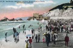 Vintage postcard of a crowded beach at Seal Rocks near Cliff House in San Francisco. People in early 20th-century attire gather by the ocean, with dramatic cliffs and the iconic building in the background.