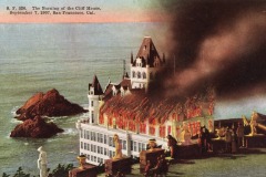 A vintage postcard illustration shows the Cliff House in San Francisco engulfed in flames and smoke on September 7, 1907, as people watch from a nearby viewpoint overlooking the ocean and rocky shoreline.