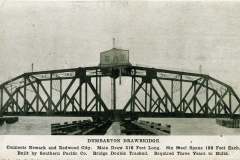Black and white photo of the Dumbarton Drawbridge with a central draw span and steel trusses. Text below details the bridges dimensions and construction.