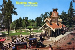 A colorful vintage postcard shows a small train station and train at Frontier Village in San Jose, California, with people walking and trees surrounding the area on a sunny day.