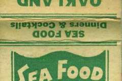 Vintage matchbook cover for Oakland Sea Food Grotto featuring green illustrations of a fish and text. Includes the phrases Sea Food Every Day and contact info for the restaurant located at Fishermans Pier, Oakland, CA.