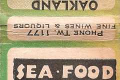 A vintage matchbook promoting the Sea Food Grotto in Oakland. It features an illustration of a lobster and text about the restaurant’s seafood specialties. The address 1069 Telegraph Ave, Oakland, is visible.