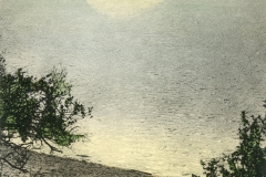 A vintage postcard depicts a serene view of Lake Merritt in Oakland, California. The lake reflects the moonlight, and the distant shore features trees and small buildings. The text reads Moonlight on Lake Merritt, Oakland, Cal.