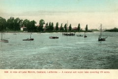 Vintage postcard image of Lake Merritt in Oakland, California, showing small sailboats on the water, a dock, and buildings with trees in the background. Text at bottom describes the lake as a 175-acre natural saltwater lake.