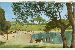 A vintage postcard of Lake Merritt in Oakland, California. People are enjoying a sunny day by the lake, with some walking and others boating. Trees frame the view, and the grassy park area is bustling with visitors.