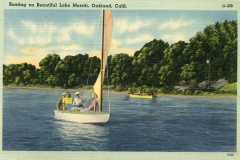 A vintage postcard illustration shows people sailing on small sailboats in Lake Merritt, Oakland, California. The boats glide over calm blue water with lush greenery and trees lining the distant shore under a partly cloudy sky.
