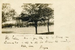 A black-and-white photograph of a high school in Livermore, California, with trees in the foreground. Handwritten text on the photo reads: Dear Eula, How do you like this big school at Livermore? I start off for Fresno this evening. With love, Papa.