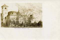 Vintage photograph of Livermore High School in California, featuring a large building with a tower, surrounded by trees. Text on the image reads High School, Livermore Cal. The image has a sepia tone, indicative of early 20th-century photography.
