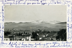 Livermore California and Mount Diablo old postcard circa 1910. Sepia-toned photograph of a small town with houses and trees in the foreground. Distant rolling hills and a snow-capped mountain range are visible under a clear sky. Handwritten text frames the image.
