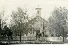 A black and white photo of a Presbyterian church with a central tower, surrounded by trees and a white picket fence. Handwritten text at the bottom reads Presbyterian Church, Livermore, Cal.