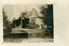 Sepia-toned photograph of a large Victorian-style house labeled Robertson Residence, Livermore, California. The house features a turret, arched windows, and a wrap-around porch, set against a backdrop of trees and a curved driveway.