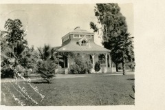 A vintage photo postcard of Solarium Building, Livermore, California. It is surrounded by palm and deciduous trees. The building has a distinctive turret and decorative arches. Handwritten notes are visible in the bottom left corner.
