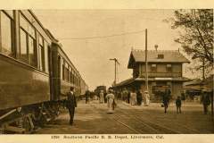 Vintage photo of Southern Pacific Railroad Depot in Livermore, California. People are standing near a train, with a station building in the background. The scene is bustling with travelers and staff on a clear day.