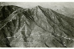 Aerial view of Mount Tamalpais with winding roads visible on a forested slope. Hills and valleys surround the mountain under a clear sky. The text reads Aero View Mt. Tamalpais, Mt. Tamalpais and Muir Woods Ry., California.