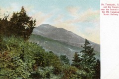 Illustration of a scenic view of Mount Tamalpais in California, featuring lush green trees and a visible mountain peak under a pastel sky. Text on the image mentions a nearby tavern and the Mount Tamalpais Scenic Railway.