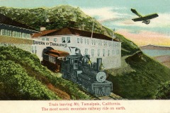 Vintage illustration of a steam train departing from the Tavern of Tamalpais, California, with mountains in the background and a small plane flying above. The text reads, Train leaving Mt. Tamalpais, California. The most scenic mountain railway ride on earth.
