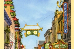 A vintage postcard depicts a bustling street scene in Chinatown, San Francisco. Colorful signs, including one for Chop Suey, line the street. Traditional Chinese architecture is visible, and classic cars are parked along the road.