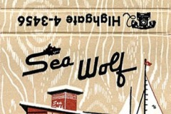 Retro matchbook cover for Sea Wolf Restaurant, showcasing a classic mid-century design. It features an illustration of the waterfront eatery by Jack London Square, complete with a sailboat and anchor. Includes address Highgate 4-3456, capturing the essence of a nautical escape.