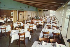 Nestled in Jack London Square, this spacious vintage-style restaurant, Sea Wolf, boasts wooden tables and chairs adorned with white tablecloths and gleaming cutlery. Large windows flood the space with natural light, highlighting the exposed wooden beams on the ceiling.