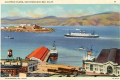 A vintage postcard illustration of Alcatraz Island in San Francisco Bay. The island is in the distance with a ferryboat and two smaller boats in the water. Buildings and piers are in the foreground, set against a backdrop of hills and a cloudy sky.