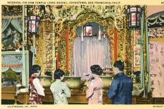 Four people stand in front of an ornate altar inside the Tin How Temple in Chinatown, San Francisco. The altar is richly decorated with intricate designs and red accents. The individuals appear to be paying their respects.