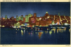 Vintage postcard illustration of San Francisco at night. The skyline is illuminated with colorful lights reflecting off the water. A prominent tower is visible on the right. Text at the top reads: “San Francisco, ‘The Queen City of the Pacific’ by Night.”.
